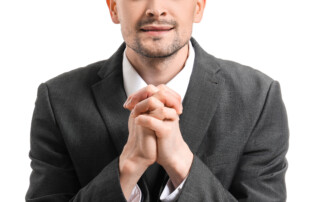 Portrait of apologizing businessman on white background